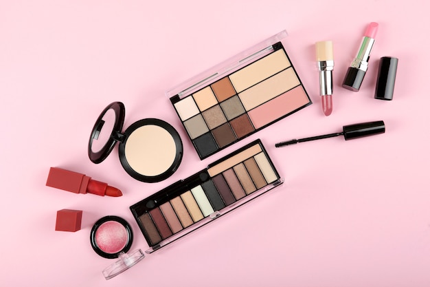 makeup products on color background top view