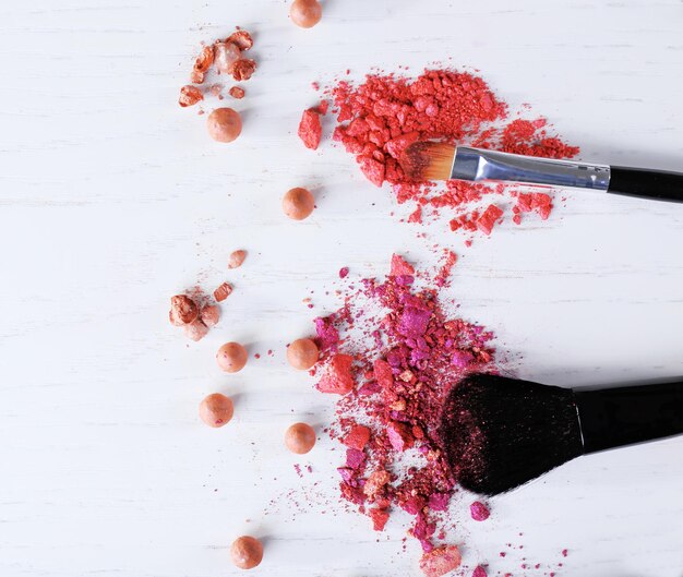 Makeup tools with powder on white background