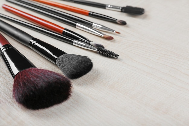 Makeup tools on a wooden background