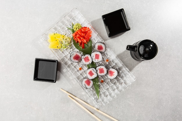 Maki Sushi Rolls with tuna served on transparent plate.