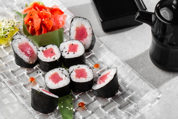 Maki sushi rolls with tuna served on transparent plate