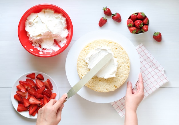 Making cake with strawberry and cream