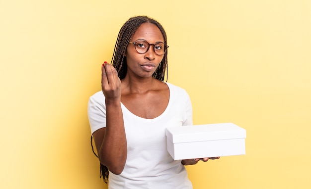 making capice or money gesture, telling you to pay your debts! and holding an empty box