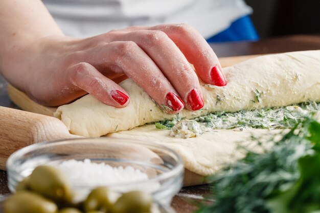 Making ciabatta bread with garlic, mediterranean olives