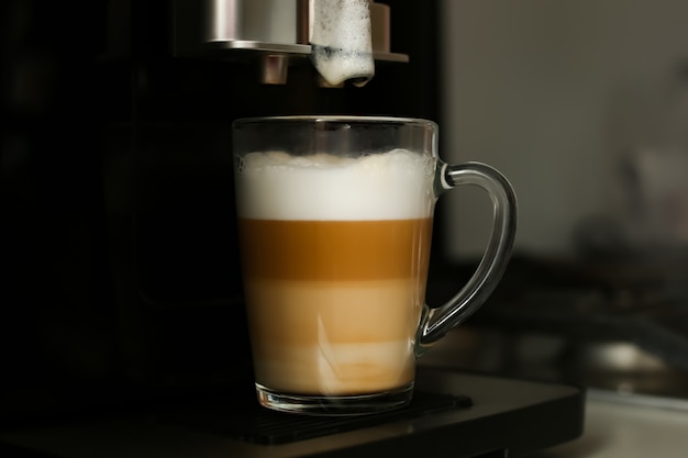 Making coffee in a coffee machine at home.