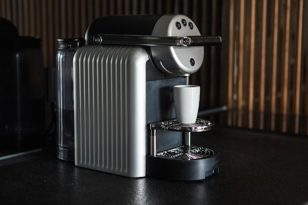 Making coffee in a coffee machine with a manual maker on the background of a table