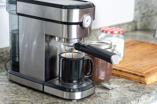 Making coffee at home with an espresso machine.