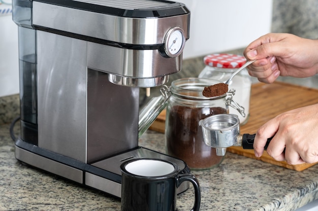 Making coffee at home with an espresso machine.