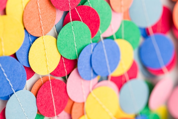 Making a colorful paper garland with reound puncher.