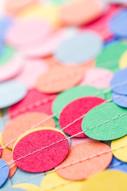 Making a colorful paper garland with reound puncher.