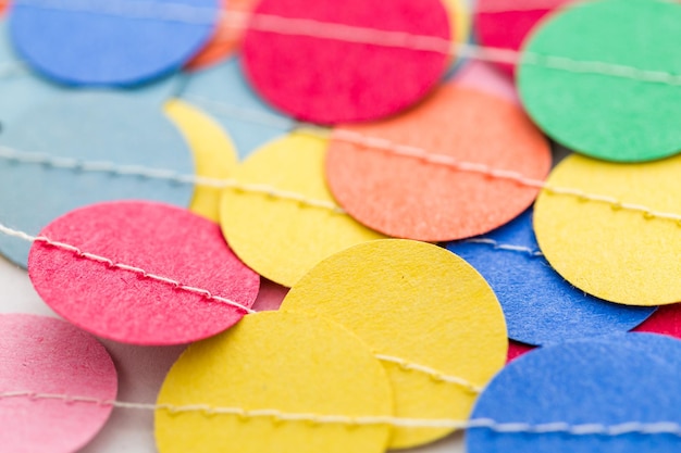 Making a colorful paper garland with reound puncher.