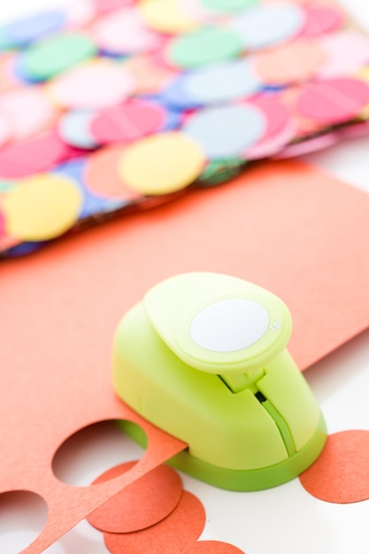 Making a colorful paper garland with reound puncher.