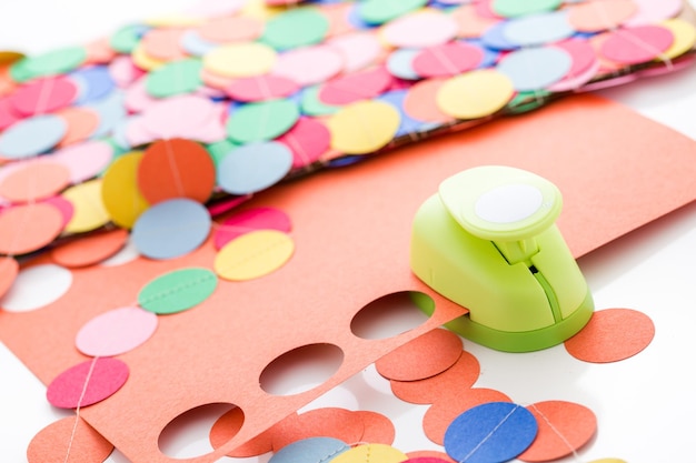 Making a colorful paper garland with reound puncher.