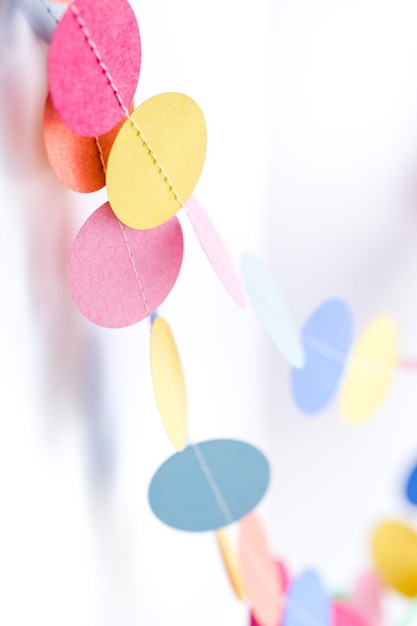 Making a colorful paper garland with reound puncher.