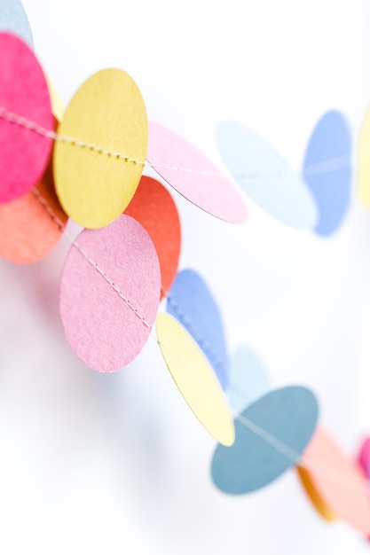Making a colorful paper garland with reound puncher.