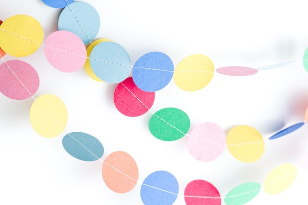 Making a colorful paper garland with reound puncher.