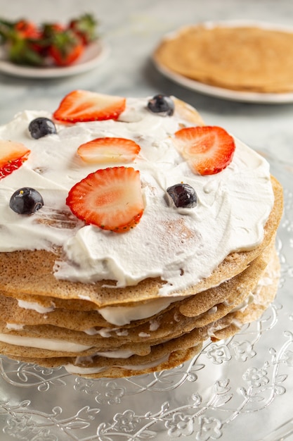 Making cooking pancake cake on a grau background close-up.