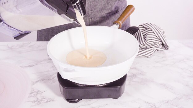 Making crepes in a small frying pan over medium heat.