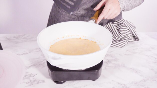 Making crepes in a small frying pan over medium heat.