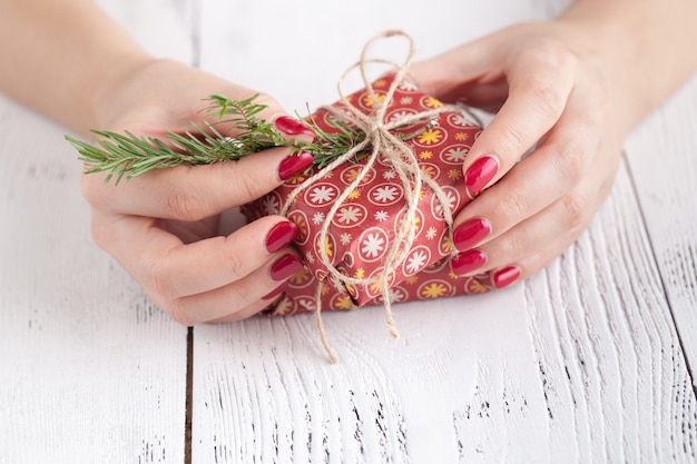 Making and decorate handmade christmas gift box on wooden surface