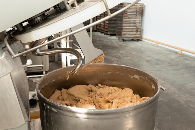 Foto fare l'impasto per il pane nell'impastatrice in panetteria impastatrice industriale per impastare