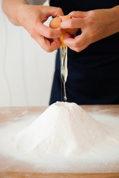 Making dough by female hands at bakery