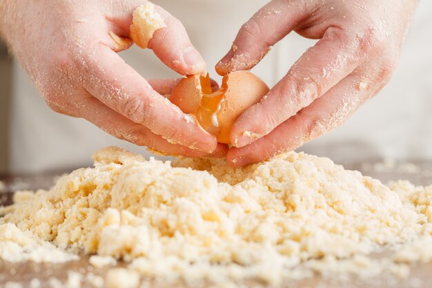 Making dough by male hands at bakery