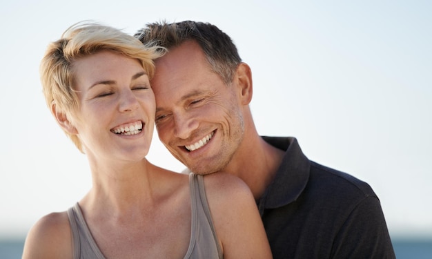 Making each other laugh Shot of a mature couple enjoying a day at the beach