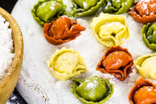 Making fresh rainbow cheese tortellini with organic produce.