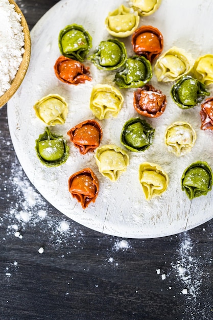 Making fresh rainbow cheese tortellini with organic produce.