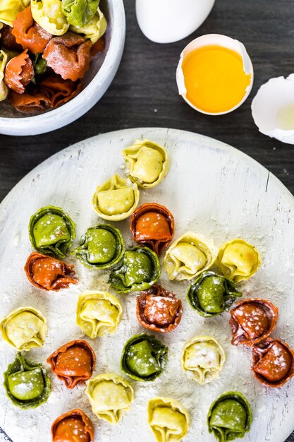 Making fresh rainbow cheese tortellini with organic produce.