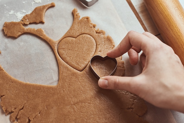 Making gingerbread cookies in shape of a heart