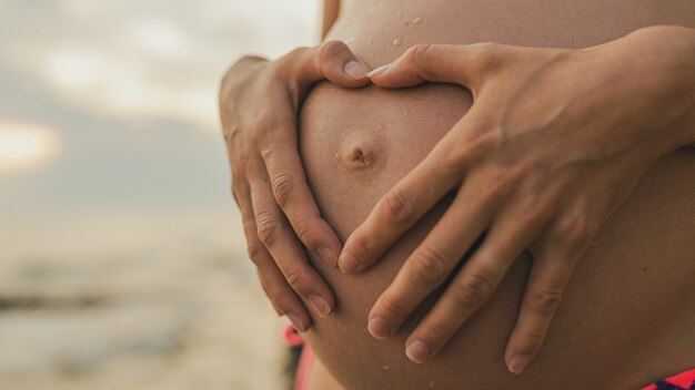 Making heart shape on pregnant belly