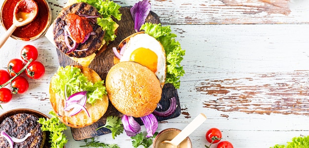 Making homemade burger. Ingredients for cooking on a wooden table.Top view or flat lay. Copy space