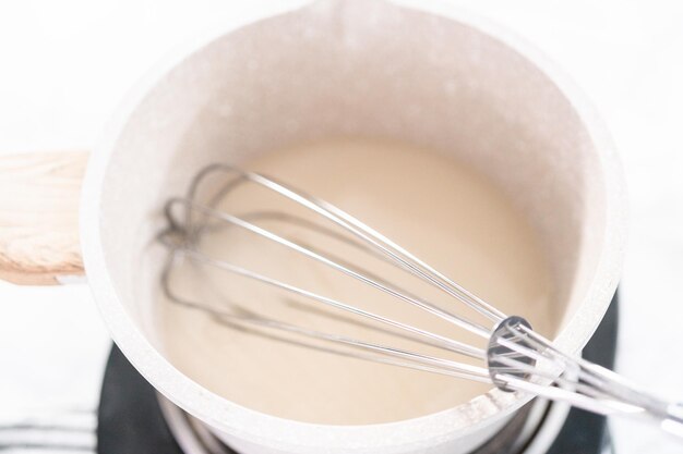 Making homemade caramel from scratch in a small saucepan.