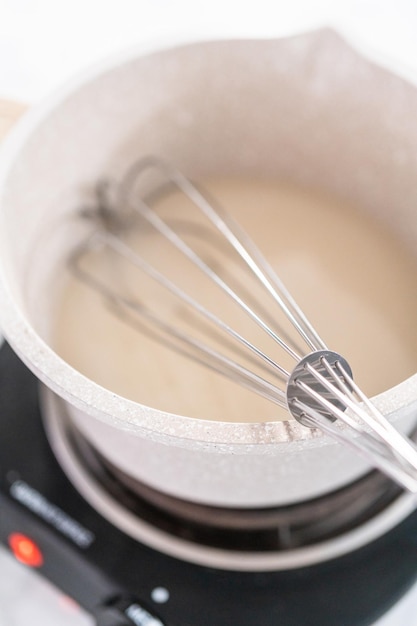 Making homemade caramel from scratch in a small saucepan.