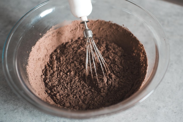 Making homemade chocolate batter in glass bowl