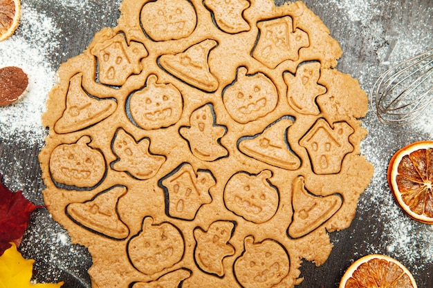 Making homemade gingerbread cookies Halloween symbols pumpkin hat ghost