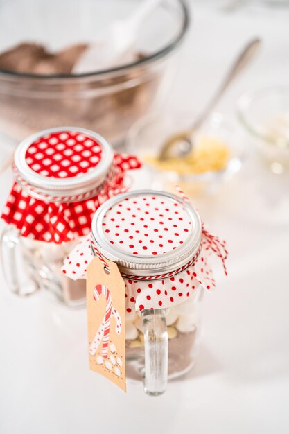 Making homemade hot chocolate mix in drinking mason jar for Christmas food gift