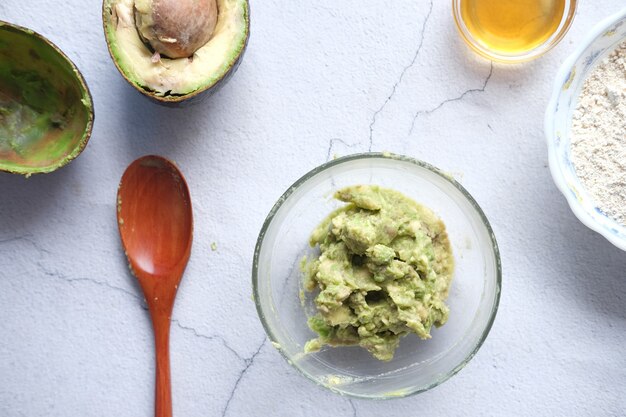 Making homemade natural avocado cosmetic on table