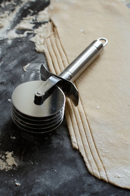 Making homemade taglatelle with a pasta rolling cutter