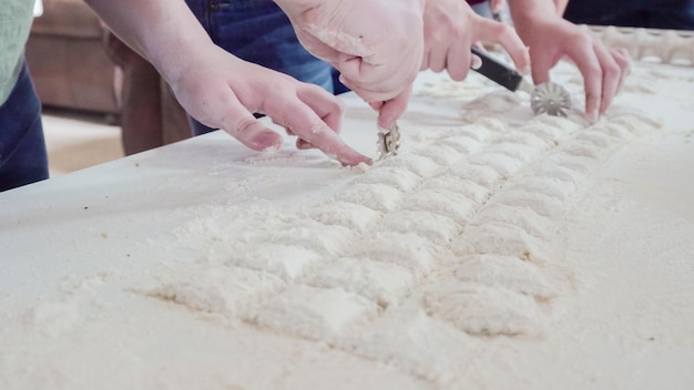 Making Italian raviolis from scratch at the Italian party.