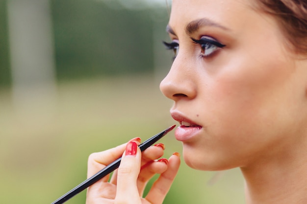 Making makeup in forest fotoshoot