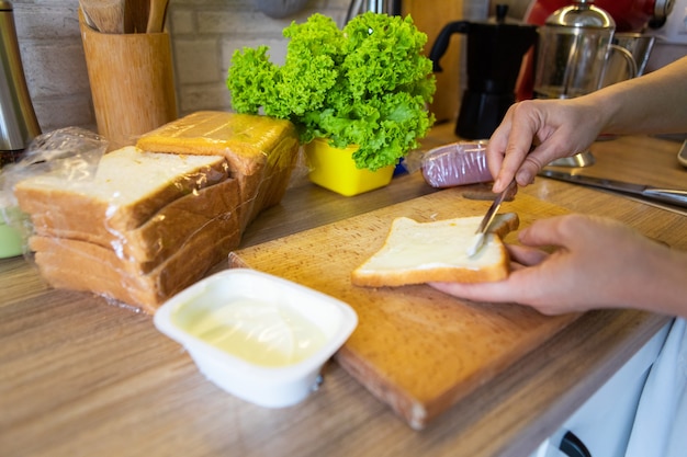 Making morning sandwich at home kitchen copy space