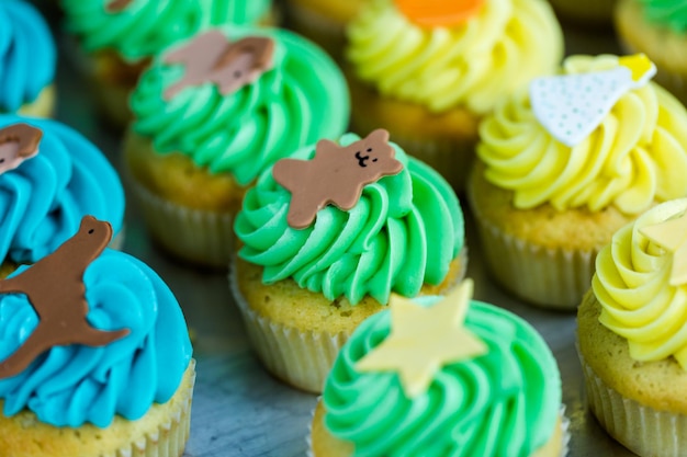 Making multicolor cupcakes for kids birthday party.