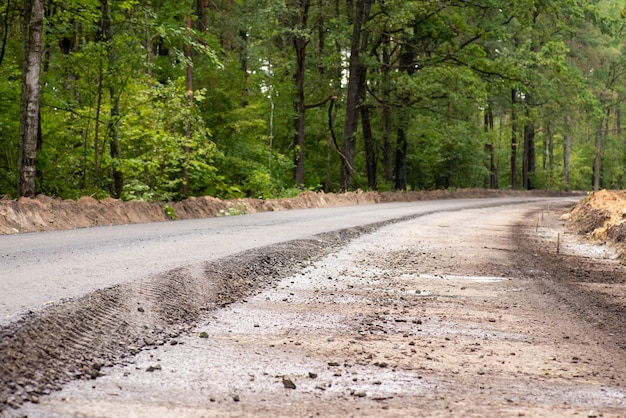 Making new asphalt road in the countryside. One lane is ready while the other one needs a finishing layer on top