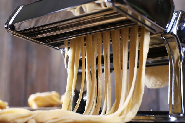 Photo making noodles with pasta machine closeup