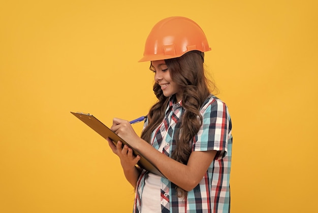 Making notes child in helmet read project construction documents signing a contract