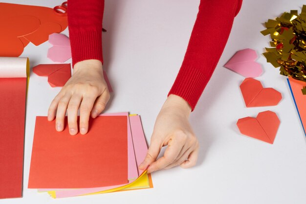 Making origami hearts for Valentine's Day