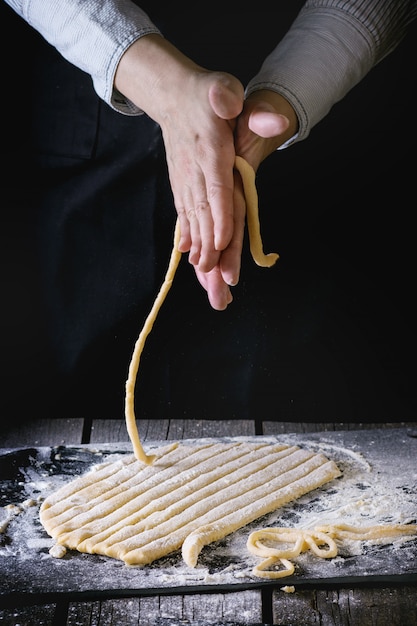 Making pasta by female hands